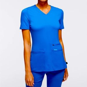 Jaanuu women’s 4 pocket V-neck scrub top. Size M